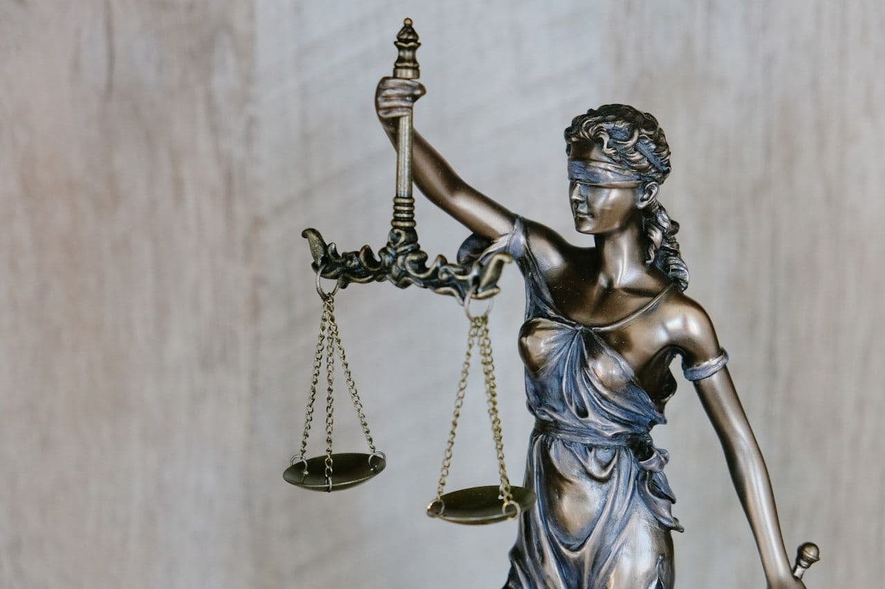 Lady Justice holding scales — legal defensibility must be built into insider risk programs from day one