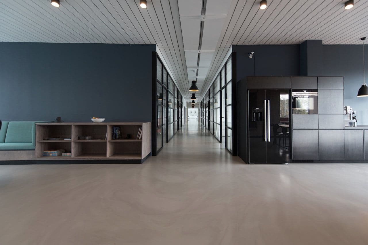 Modern office corridor with glass partitions — insiders operate within the spaces organizations trust them to access