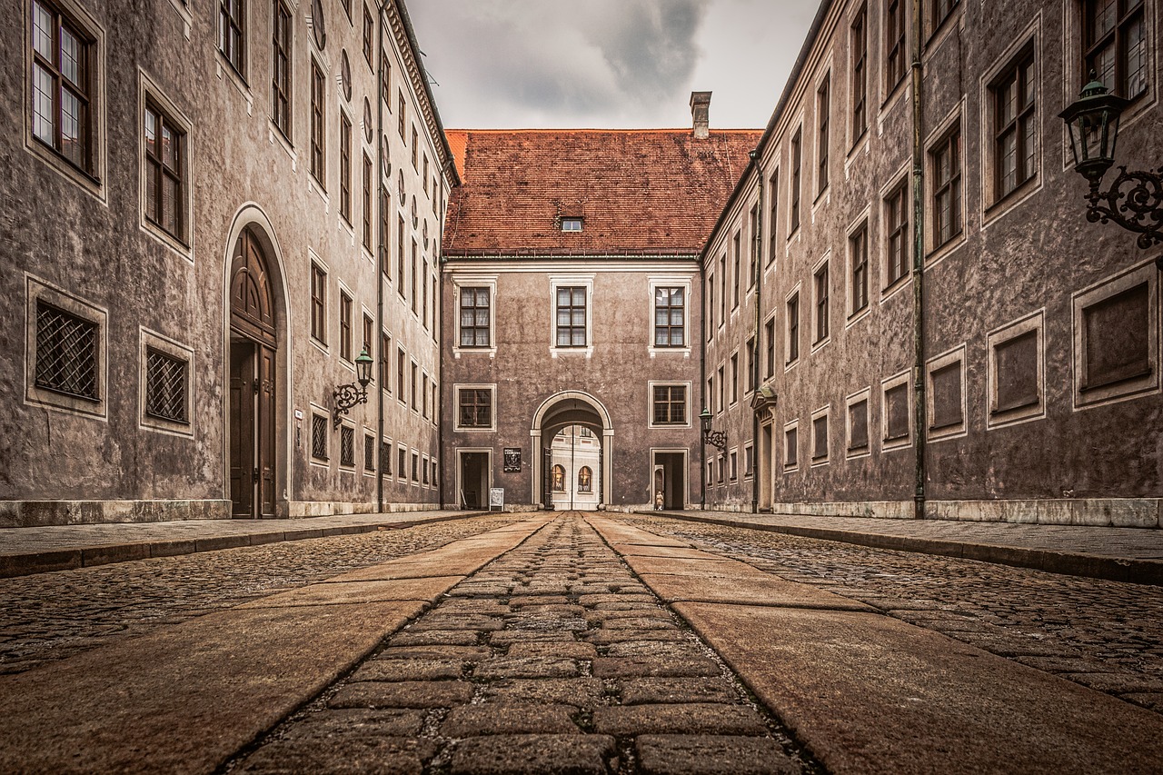Historic European architecture symbolizing integrity protection, whistleblowing advocacy, and institutional strength for legal compliance in Munich and London